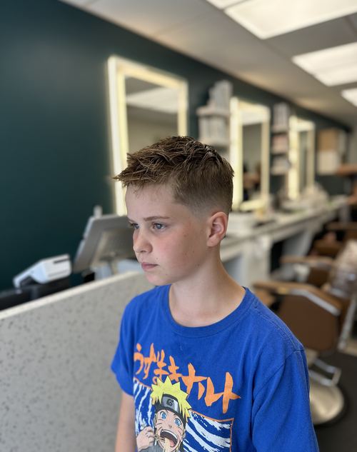Kid's textured fringe haircut with a fade